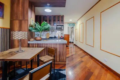 a kitchen with wooden floors and a table in a room at Lima Virreinal & primer piso muy acogedor in Lima
