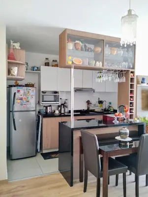 a kitchen with a table and a refrigerator at Confortable habitación baño privado desayuno opcional in Lima