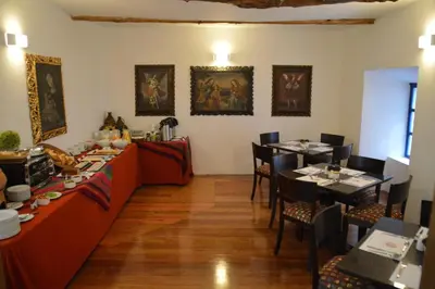 a dining room with a long table and two tables at Tierra Viva Cusco San Blas in Cusco