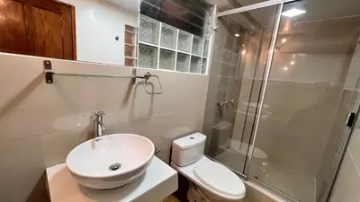 a bathroom with a shower and a toilet and a sink at QUECHUA´S HOUSE Hostal & Coffee in Machu Picchu
