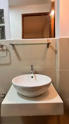 a white sink on a counter in a bathroom at QUECHUA´S HOUSE Hostal & Coffee in Machu Picchu