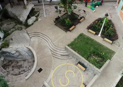 an overhead view of a park with a spiral staircase at QUECHUA´S HOUSE Hostal & Coffee in Machu Picchu