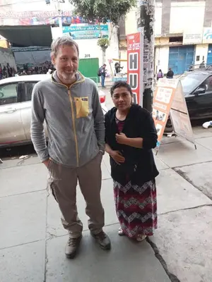 a man and a woman standing on a sidewalk at Posada Ternura in Lima