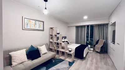 a living room with a couch and a bed at Loft céntrico San borja - San Isidro in Lima