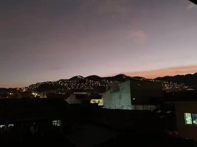 a view of a city at night with a mountain at Centric & cozy apartment with Garage in Cusco
