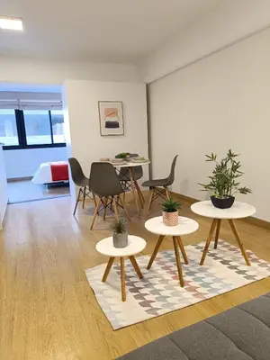 a room with two tables and chairs with plants at Runawasi Loft - Raywa 1 BDR, Centric and confortable. in Lima
