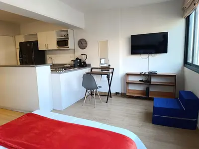 a room with a kitchen and a living room at Runawasi Loft - Raywa 1 BDR, Centric and confortable. in Lima