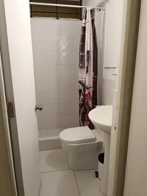 a bathroom with a toilet and a sink at Runawasi Loft - Raywa 1 BDR, Centric and confortable. in Lima