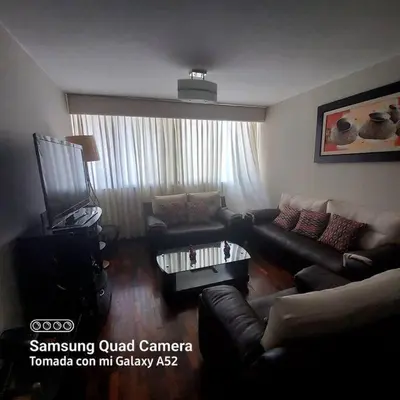 a living room with a couch and a coffee table at APARTAMENTO 502 in Lima