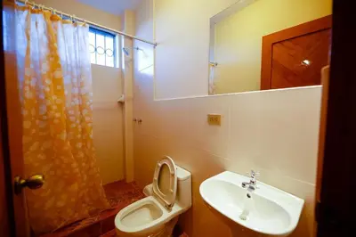 a bathroom with a sink and a toilet and a mirror at BROTHERs HOUSE II in Cusco