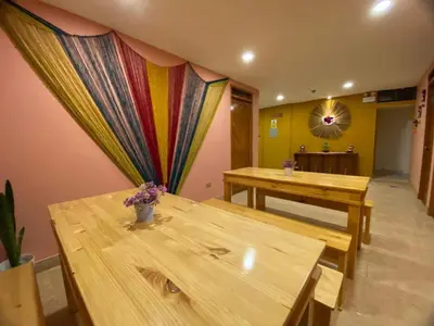a room with two wooden tables and a curtain at BROTHERs HOUSE II in Cusco