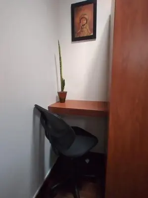 a desk with a black chair and a plant at Centric, private, petfriendly budget apartments in Miraflores in Lima