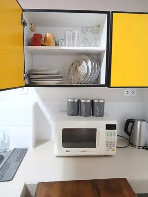 a microwave oven in a kitchen with some dishes at Centric, private, petfriendly budget apartments in Miraflores in Lima