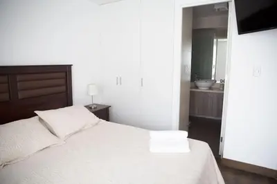 a bedroom with a white bed with two towels on it at Barranco Perfect Location - Apartament in Lima