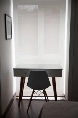 a desk with a chair in front of a window at Barranco Perfect Location - Apartament in Lima