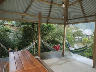 a group of people laying in hammocks in a tent at SONCCO LODGE-RESTAURANT in Quillabamba
