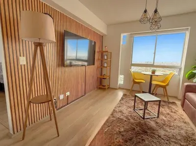 a living room with a couch and a table at Exclusivo con vista panorámica al mar - Ocean View in Lima