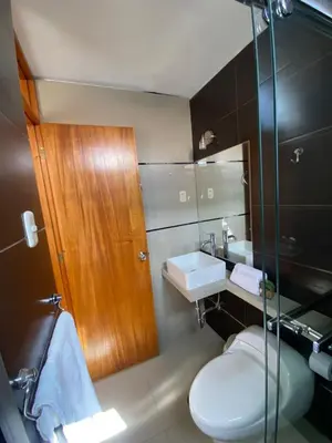 a bathroom with a toilet and a sink and a shower at LA FAMILIA NASCA HOUSE in Nazca