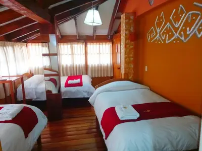 a bedroom with three beds in a room at Andenes del Sol in Cusco
