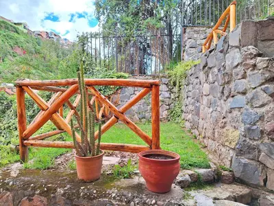 a plant in a pot next to a stone wall at Andenes del Sol in Cusco