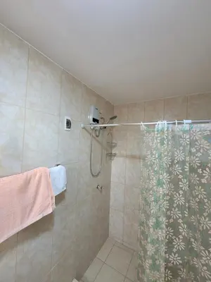 a bathroom with a shower with a shower curtain at Habitación con baño propio para 2 personas como máximo in Lima
