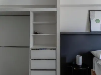 a closet with white shelves in a bedroom at Cozy 2BR Loft in the Heart of Miraflores in Lima
