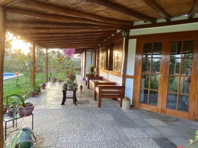 a patio with benches and tables on a house at Casa de campo con piscina en Asia in Asia