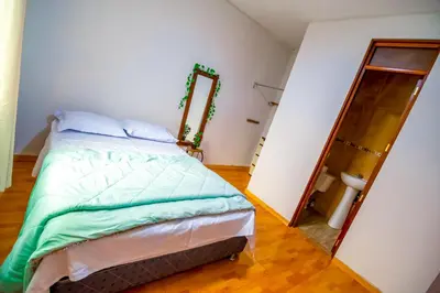 a bedroom with a bed and a mirror at Casa de Campo en Lunahuaná con jardin amplio para Familias y Amigos in Lunahuaná