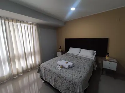 a bedroom with a bed with two towels on it at Inti Llaqta Hotel & Suites in Lima