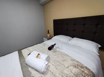 a bedroom with a large bed with towels on it at Inti Llaqta Hotel & Suites in Lima