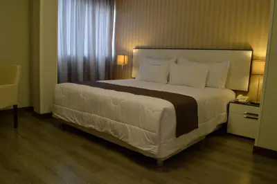 a bedroom with a large bed with white pillows at LimaQ Hotel in Lima