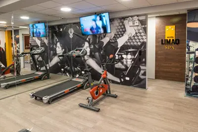 a gym with cardio equipment and a wall mural at LimaQ Hotel in Lima