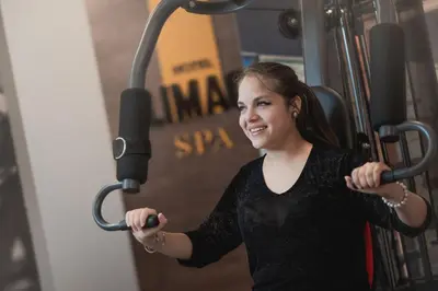a young woman is working out in a gym at LimaQ Hotel in Lima