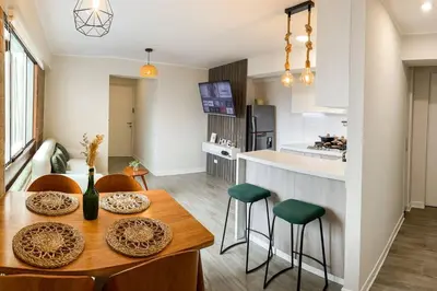 a kitchen and dining room with a table and chairs at Miraflores House C&F in Lima