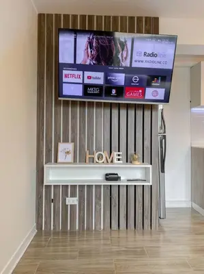 a flat screen tv on a wall in a living room at Miraflores House C&F in Lima