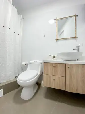 a bathroom with a white toilet and a sink at Miraflores House C&F in Lima
