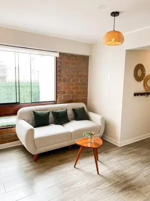a living room with a couch and a table at Miraflores House C&F in Lima
