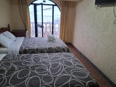 a hotel room with two beds and a window at HOTEL CHORRILLOS BEACH in Barranca