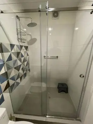 a shower with a glass door in a bathroom at Beautiful loft at heart of Lima in Lima