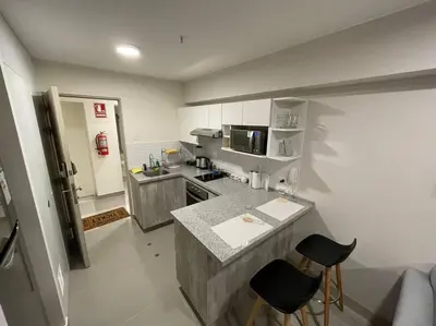 a small kitchen with a counter and a counter top at Beautiful loft at heart of Lima in Lima