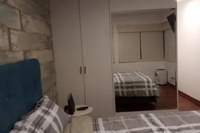 a bedroom with a mirror next to a bed at A beautiful place in the heart of Miraflores in Lima