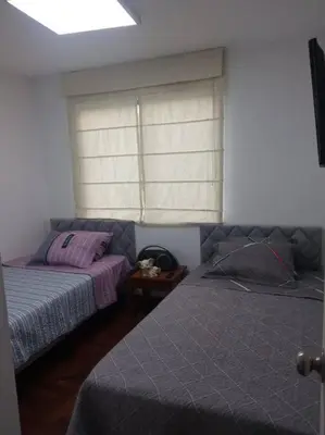 a bedroom with two beds and a window at A beautiful place in the heart of Miraflores in Lima