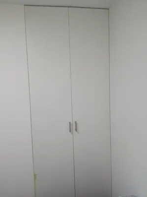 a pair of tall white cabinets in a room at A beautiful place in the heart of Miraflores in Lima