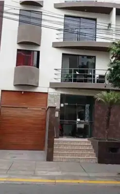 a building with a wooden door and a balcony at A beautiful place in the heart of Miraflores in Lima
