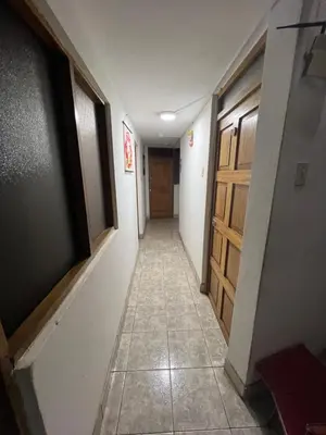 a hallway with a door and a tile floor at Euro Hostal in Cusco