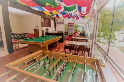 a room with a pool table and a table at Casa Machu Picchu Hostel in Machu Picchu