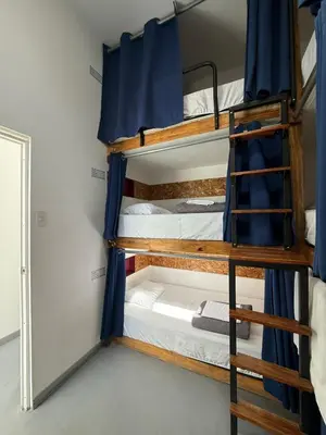 a bunk bed room with two bunk beds in it at SG Paracas Hostel in Paracas