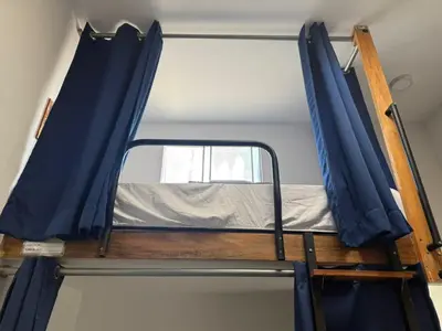a bunk bed in a room with a mirror at SG Paracas Hostel in Paracas