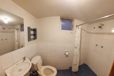 a bathroom with a toilet and a sink and a shower at Mirador de la Ñusta in Cusco