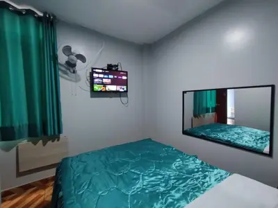 a bedroom with a bed and a large mirror at Hostal El Pilar in Lima